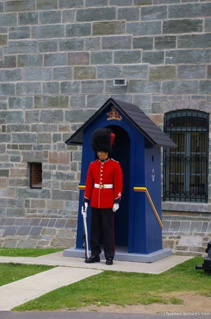 Guard in black furry hat and red jacket on guard at La Citadelle in Quebec.jpg
